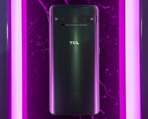 TCL 10 Pro in grey colourway next to purple lights