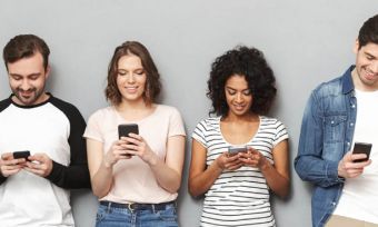 Young friend group using mobile phones