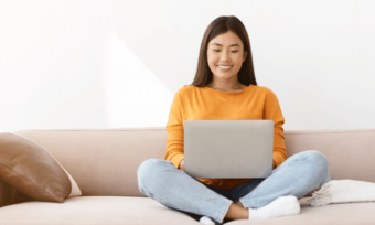 Happy woman using laptop at home