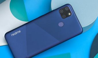 Realme C12 smartphone in blue colour against background with various blue shapes