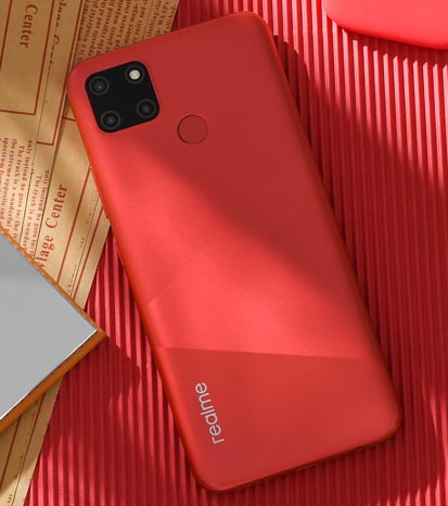 Realme C12 phone in red colou against red textured background