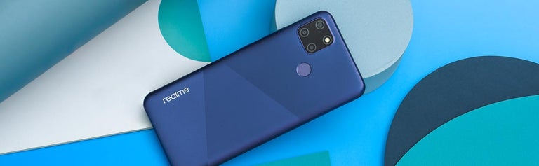 Realme C12 smartphone in blue colour against background with various blue shapes