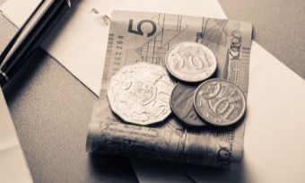 Australian money notes on desk with pen