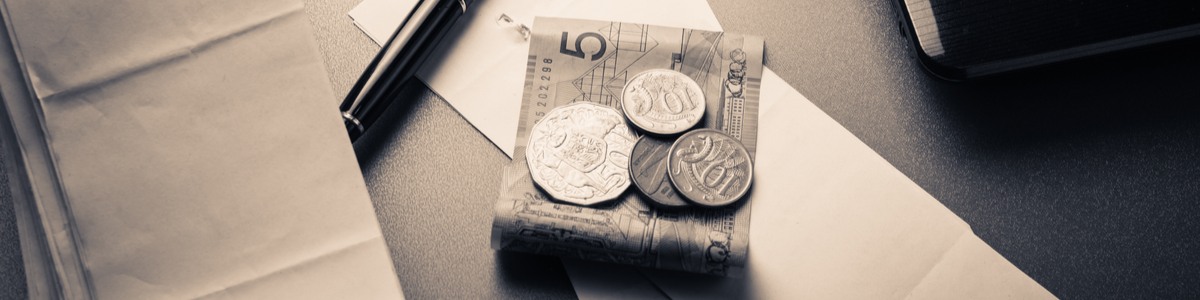 Australian money notes on desk with pen