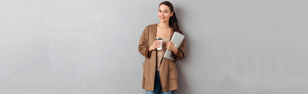 Young woman holding tablet and coffee