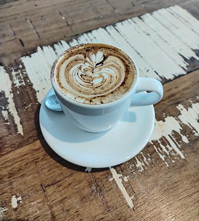 Coffee in mug on wooden table