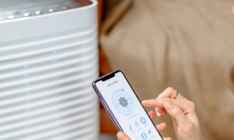 Woman setting temperature on cooler with phone