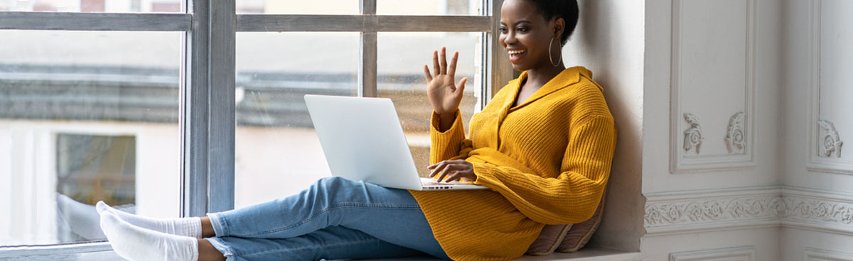 Young woman using laptop to video chat