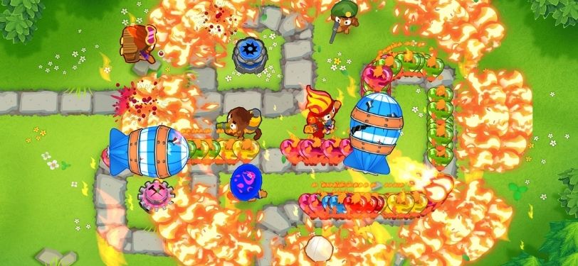 A screenshot from the game Bloons TD 6, where you're tasked with defending a map by popping balloons using an army of monkeys
