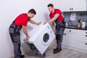 Men moving washing machine