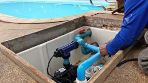 Technician fixing pool pump