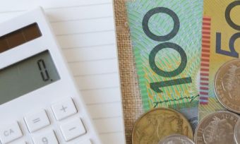 Calculator next to money and a notepad