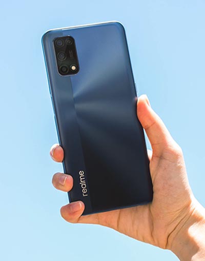 person holding Realme 7 5G phone in blue colourway