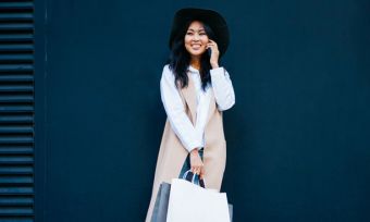 Smiling young woman using mobile phone