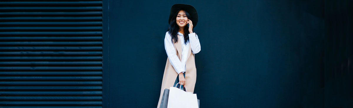 Smiling young woman using mobile phone