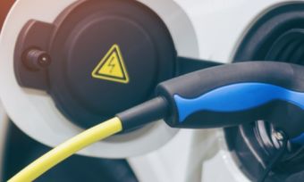 Electric vehicle charger plugged into car