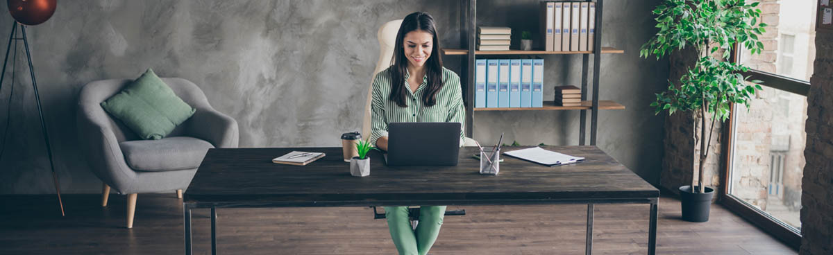 Business owner in office using laptop