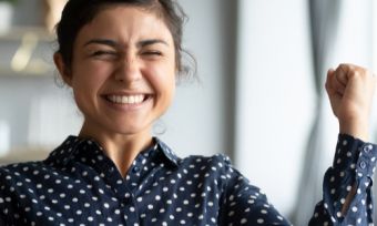 Young happy lady smiling in front of laptop