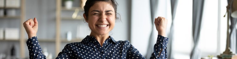 Young happy lady smiling in front of laptop