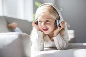 Child listening to music on headphones