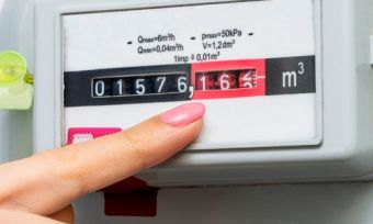 Woman hand pointing at natural gas meter