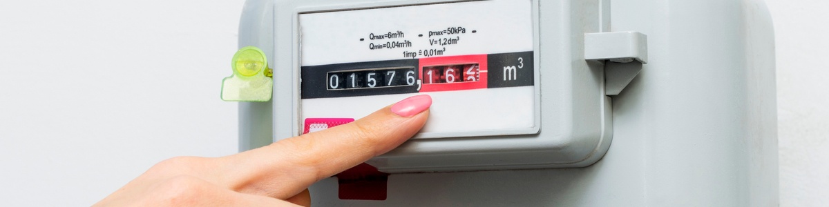 Woman hand pointing at natural gas meter