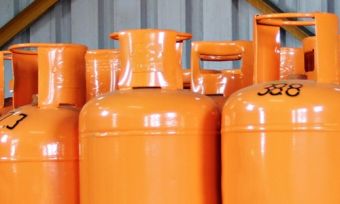 Orange LPG gas cylinders lined up