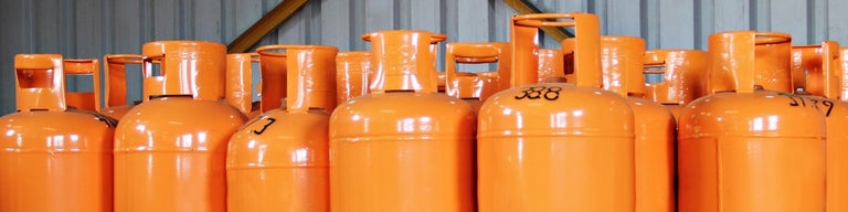 Orange LPG gas cylinders lined up