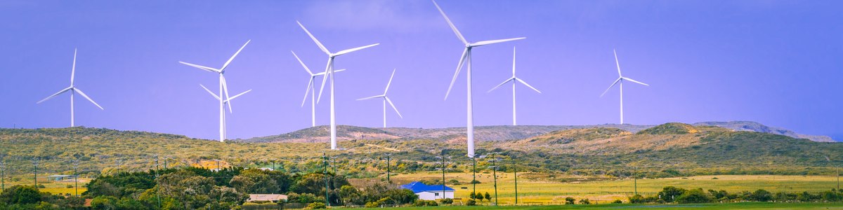 Wind turbines on hillside on farm