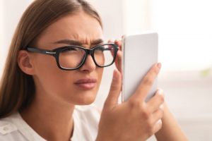 Woman squinting at phone