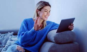Smiling woman using tablet at home