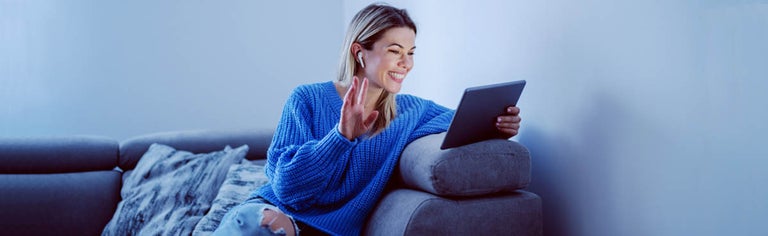 Smiling woman using tablet at home