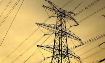 Electricity towers and wires at sunset