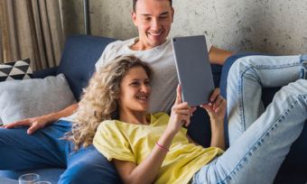 Young couple watching tablet together at home