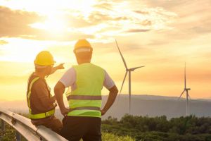 Workers looking at wind turbines