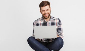 Young man using laptop against white background