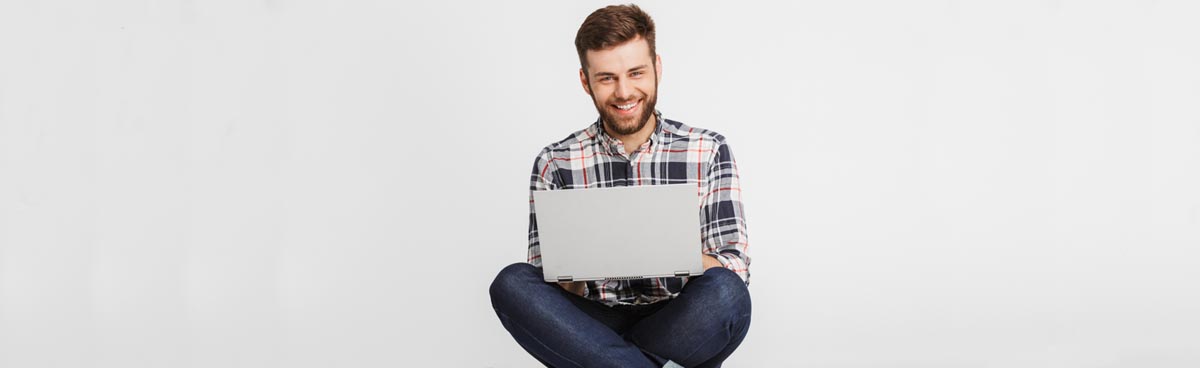 Young man using laptop against white background