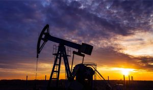 Working gas and oil rig at sunset