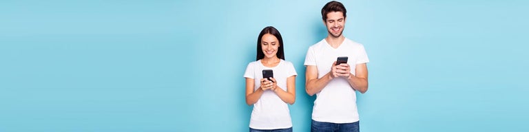 Woman and man looking at phones against blue background