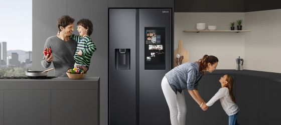 Samsung fridge in kitchen with a family