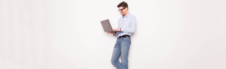 Young man with glasses using laptop