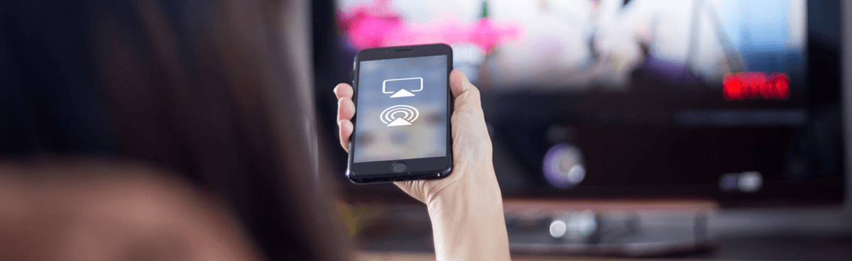 Woman screencasting from phone to TV