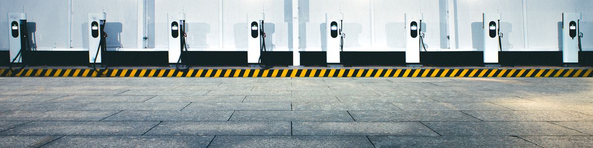 EV charging stations lined up against a wall