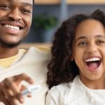 Father and daughter watching movies