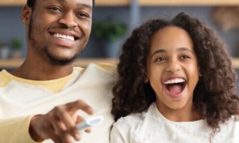 Father and daughter watching movies