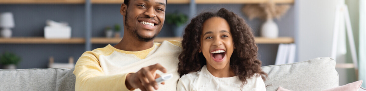 Father and daughter watching movies