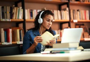 Female student studying online in library