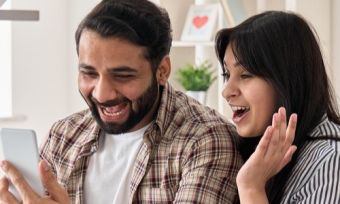 Happy couple looking at something on the phone