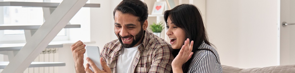 Happy couple looking at something on the phone