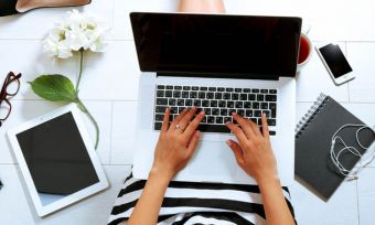 Overhead shot of young professional woman using laptop